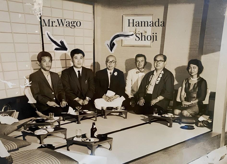 Joji Wago seated with the potter Hamada Shoji and others in a tatami room.