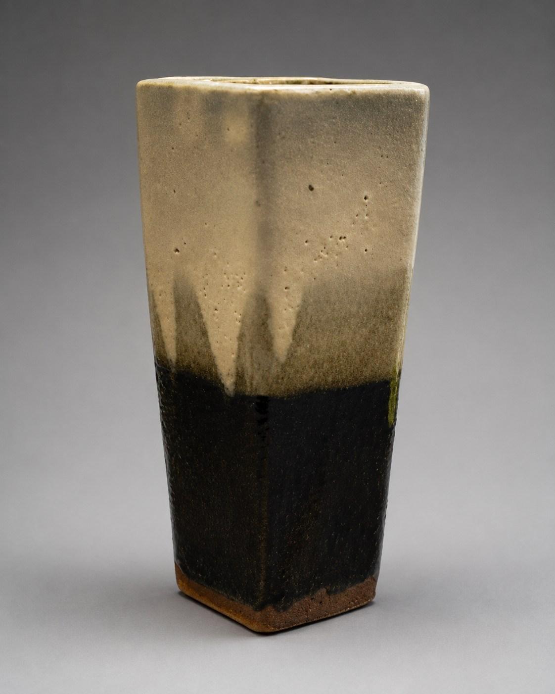 Hamada Shoji — Vase, triangular, poured glaze. A Hexagonal Stoneware Vase with Poured Iron Glaze Design, Japanese stoneware, Showa period, 20th century.